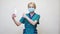 Medical doctor nurse wearing protective mask - holding sanitizing spray or gel or liquid soap