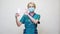 Medical doctor nurse wearing protective mask - holding sanitizing spray or gel or liquid soap