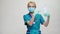 Medical doctor nurse wearing protective mask - holding sanitizing spray or gel or liquid soap