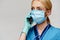 Medical doctor nurse woman with stethoscope wearing protective mask and rubber or latex gloves talking on mobile cell