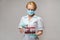 Medical doctor nurse woman wearing protective mask and gloves - holding rack with virus blood tests
