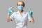 Medical doctor nurse woman wearing protective mask and gloves - holding virus blood test