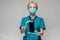 Medical doctor nurse woman wearing protective mask and gloves - showing presenting mobile phone