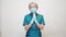 Medical doctor nurse woman wearing protective mask and latex gloves - praying nad hoping gesture