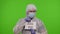 Medical doctor in PPE suit with text on paper - We Are In Quarantine, Sorry No Visitors, coronavirus