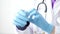 Medical doctor puting on blue latex gloves