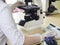 Medical doctor in a white coat doing a blood test on the microscope, close-up, medical