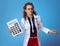 Medical doctor woman with big white calculator shrug on blue