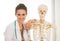 Medical doctor woman near human skeleton