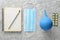 Medical equipment on a gray concrete background. Enema, pills, notepad. Medical concept, top view, flat lay style.