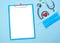 Medical equipment mockup clipboard, stethoscope with red heart and drug, surgical mask on blue copy space background