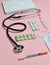 Medical equipment on a pink pastel background. Blisters pills