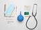 Medical equipment on a white background. Stethoscope, tablet, thermometer, notebook, syringe, enema. Medical concept, top view