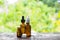 Medical essential oil bottles. Medical essential oil on wooden desk. Essential oil on floral background