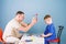 Medical examination. Medical service. Man doctor sit table medical tools examining little boy patient. Pediatrician