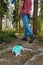 Medical face mask littering in nature.Unrecognizable man walks away after dropping a mask on the ground on a footpath in the