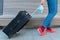 Medical face mask, luggage in hand and legs of woman