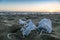 Medical face masks discarded on sea coast over sunset background,covid19 pandemic disease pollution