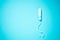 Medical female tampon on a blue background with copy space. Hygienic white tampon for women. Cotton swab. Menstruation, means of