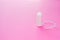 Medical female tampon on a pink background. Hygienic white tampon for women. Cotton swab. Menstruation, means of protection.
