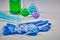 Medical flasks with colorful chemical reagents. Seven mockup ampoules and syringe on blue disposable gloves, mask