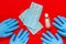 Medical glove, protective  face masks  and sanitizer on a red background. Protection against dangerous  viruses. Viral infection s