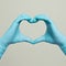 Medical gloves heart shape hands. Blue doctor gloves