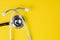Medical, health care or hospital concept, stethoscope on yellow