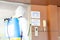 Medical health care worker in protective white jumpsuit and pumping spraying machine disinfected virus pandemic