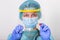 Medical healthcare holding COVID-19 , Coronavirus swab collection kit, wearing PPE protective suit mask gloves, test tube for