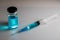 Medical hypodermic syringe in blue colour.