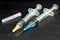 Medical injection syringe with solution on black background