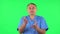 Medical man emotionally looks at something, comments and then disappointedly gives up hands. Green screen