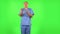 Medical man emotionally looks at something, comments and then disappointedly gives up hands. Green screen