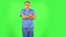 Medical man folds his arms over his chest and looks seriously at the camera. Green screen