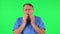 Medical man got a cold, sore throat and head, cough on green screen at studio. Green screen