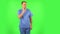 Medical man looks around, covers his mouth with his hand and whispers the secret and making a hush gesture. Green screen