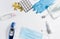 Medical mask, electronic thermometer, pills, gloves, antiseptic saline solution on a white isolated background, top view. Health