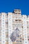 Medical mask on a flagpole. White flag on the background of high-rise buildings.