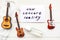 Medical mask, guitars and card with message New Concert Reality on wooden background.
