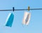 Medical mask hanging outdoors against clean blue sky