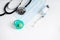 Medical mask, stethoscope, syringe with medicine and pacifier on a light background. Vaccinations for children