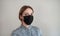 A medical mask on a woman `s face. Black mask to protect against bacteria, dust and viruses