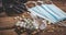 Medical masks, pills, antiseptic in a transparent plastic bottle and black rubber gloves on a wooden background. Covid-19 virus