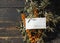 Medical masks with sea buckthorn branches on a dark wooden natural table.The idea of protecting and treating influenza with folk