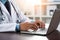 Medical Mastery: Doctor Typing on Laptop with Stethoscope, close up hands