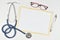Medical mock-up with blank sheet of paper, clipboard, stethoscope, glasses on doctor desk. Health care concept. Top view