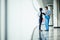 Medical multiethnic staff having discussion in a hospital hallway. Two doctors working in a medical clinic. Two hospital workers d