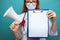 Medical news. Woman holding tablet in the blue cabinet