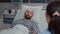 Medical nurse explaining bones x-ray to hospitalized sick man during disease recovery